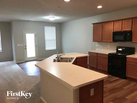 A kitchen with wooden cabinets and a white countertop.