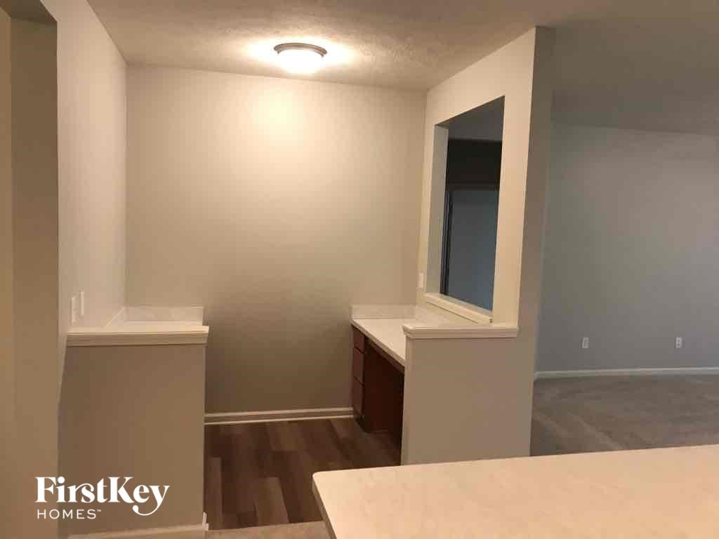 A room with a window and a bed in it.