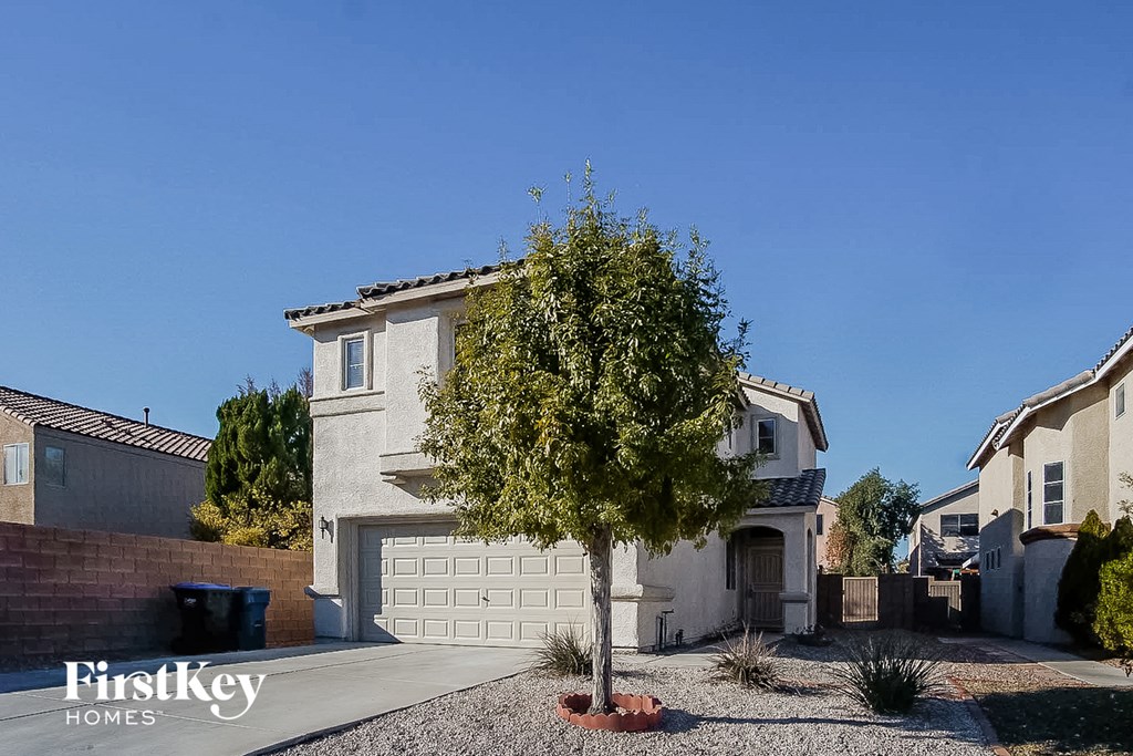 A house with a tree in front of it.