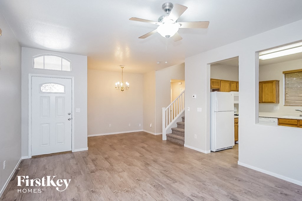 A spacious room with a staircase leading to the upper floor.