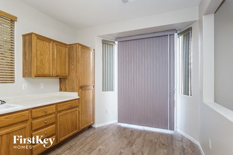 A kitchen with wooden cabinets and a sink.