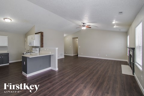 A kitchen area with a counter and a fridge.