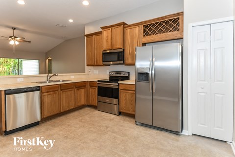 A kitchen with wooden cabinets and stainless steel appliances.