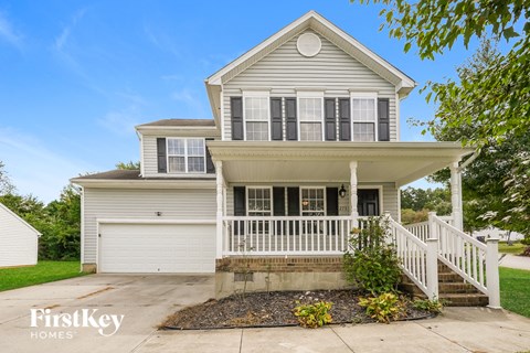 A two-story house with a garage and a front porch.