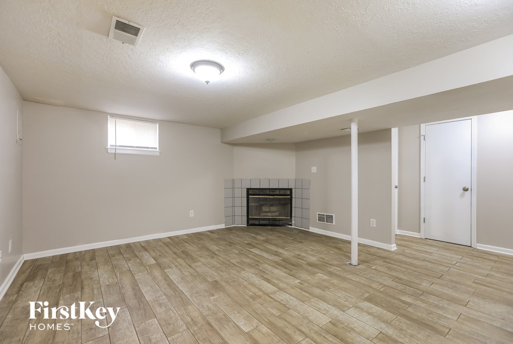 a living room with a fireplace and a wooden floor