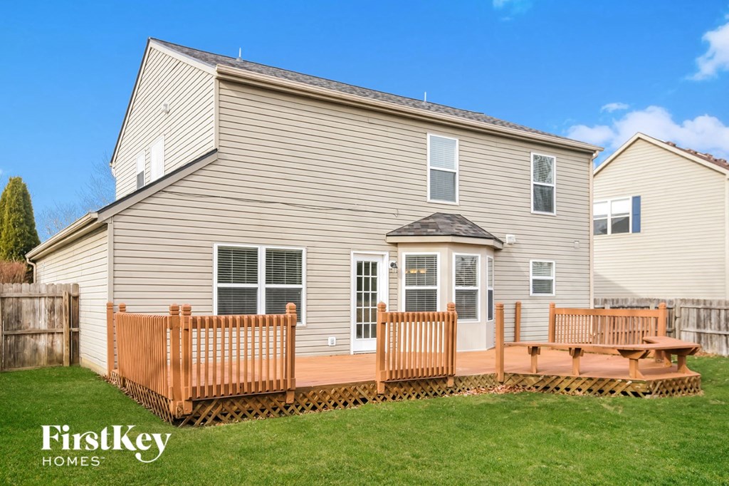 a large house with a wooden deck in front of it