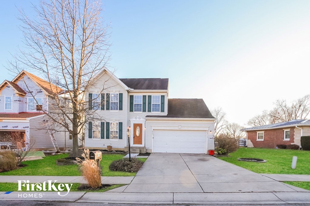 a white house with a sidewalk in front of it