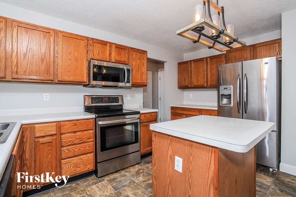 a kitchen with wooden cabinets and stainless steel appliances