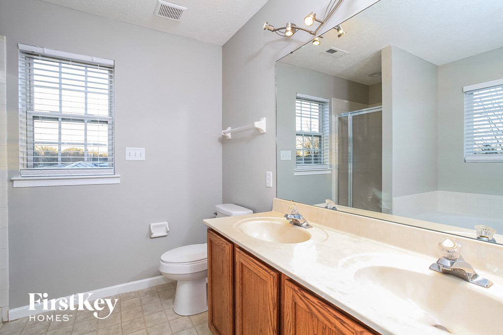 a bathroom with a sink and a toilet and a mirror