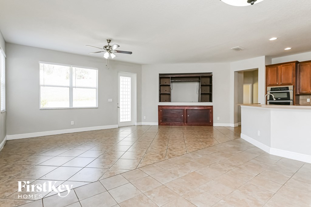 an empty kitchen and living room with tile flooring
