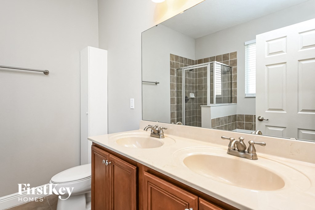 a bathroom with two sinks and a large mirror