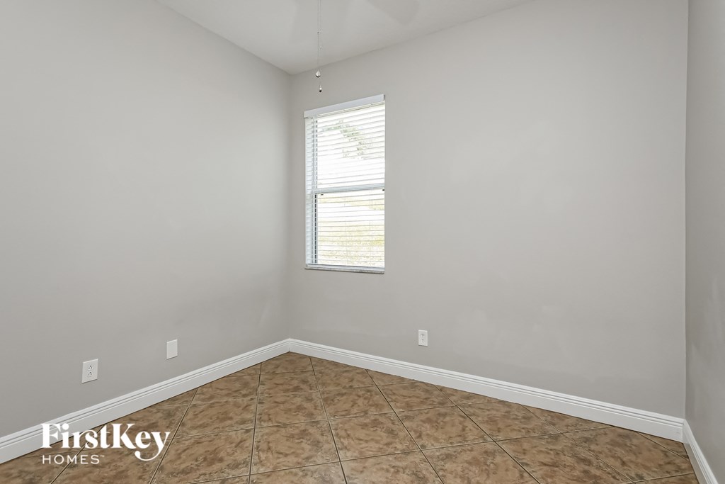 a empty room with a window and a tiled floor