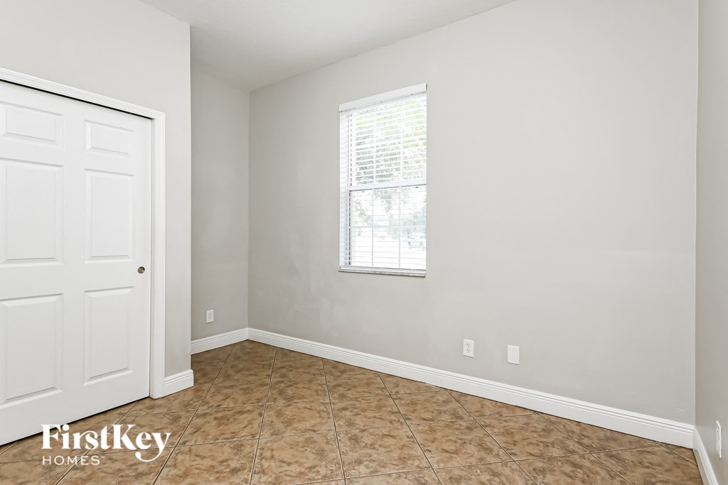 an empty room with a window and a door