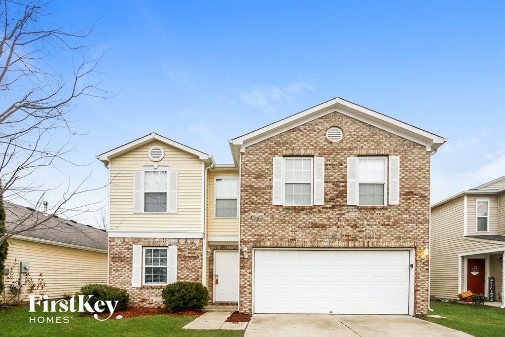 a brick house with a white garage door