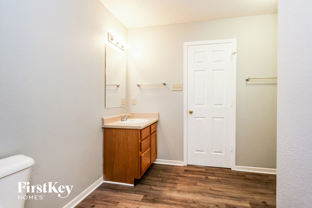 a bathroom with a sink and a white door