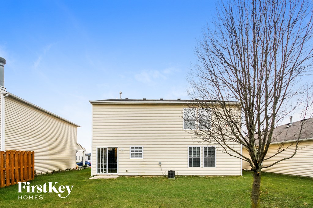 a white house with a tree in front of it