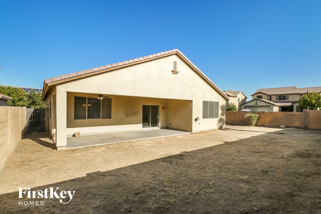 a small white house with a driveway and a garage door