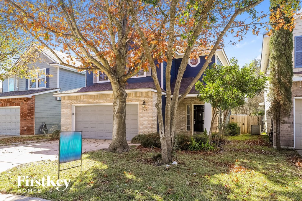 a blue chair in a yard in front of a house