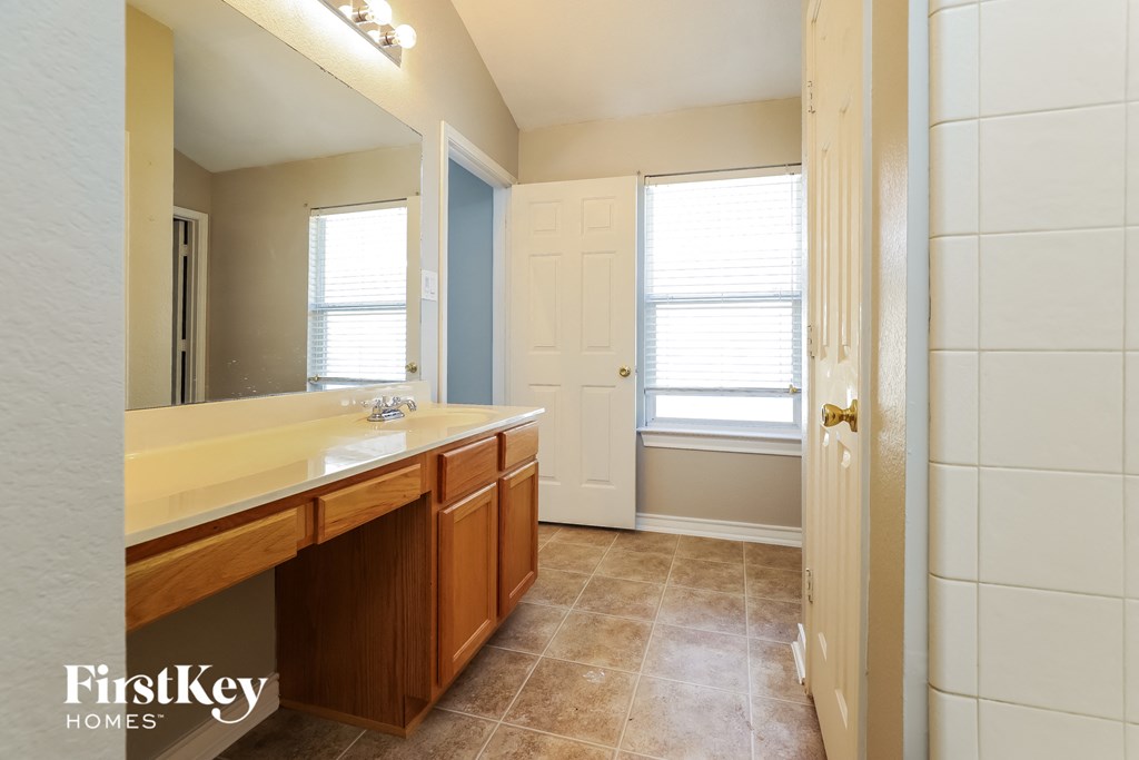 a bathroom with a large mirror and a sink