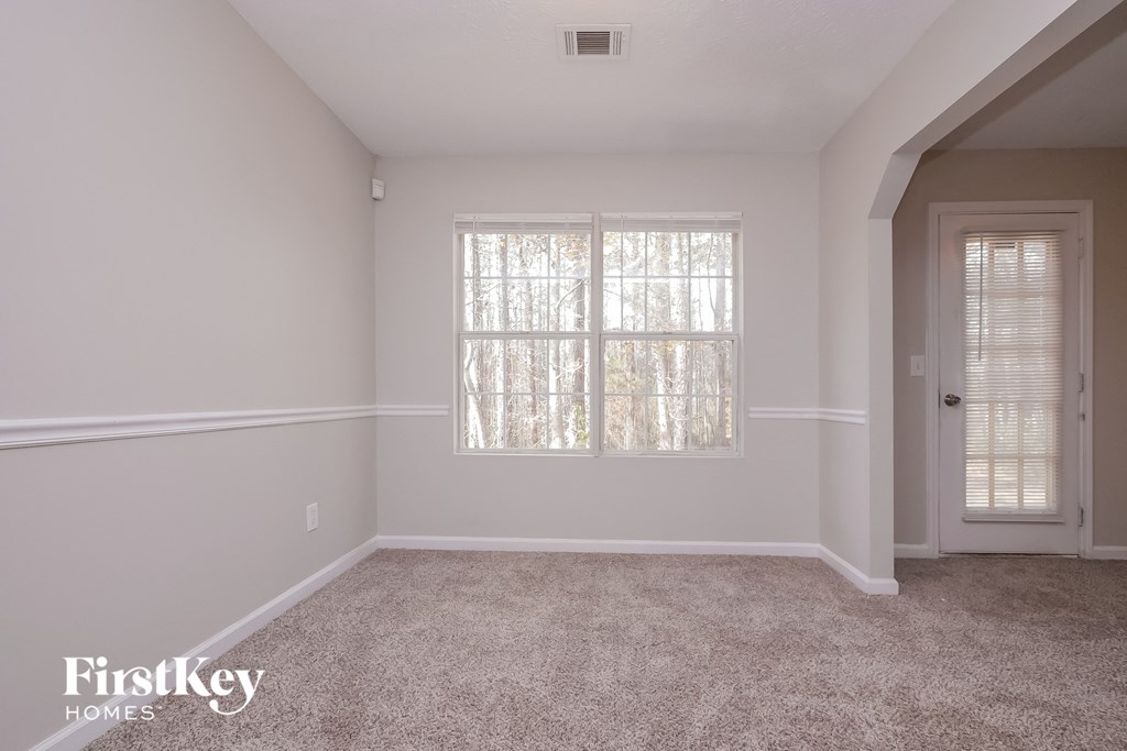 a room with carpet and a window and a door