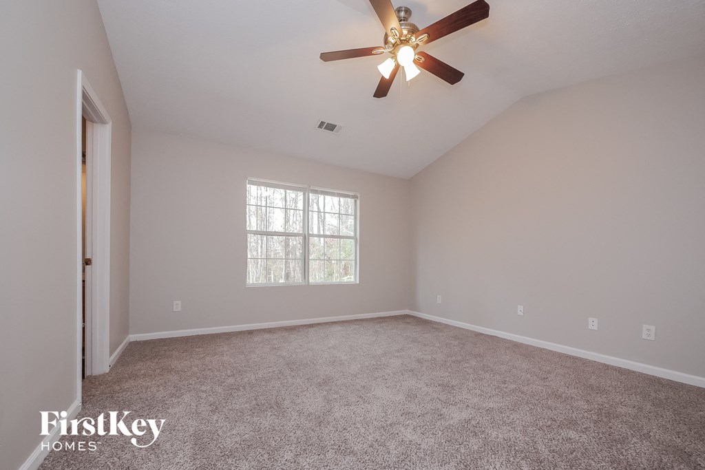 the master bedroom is spacious and has a ceiling fan