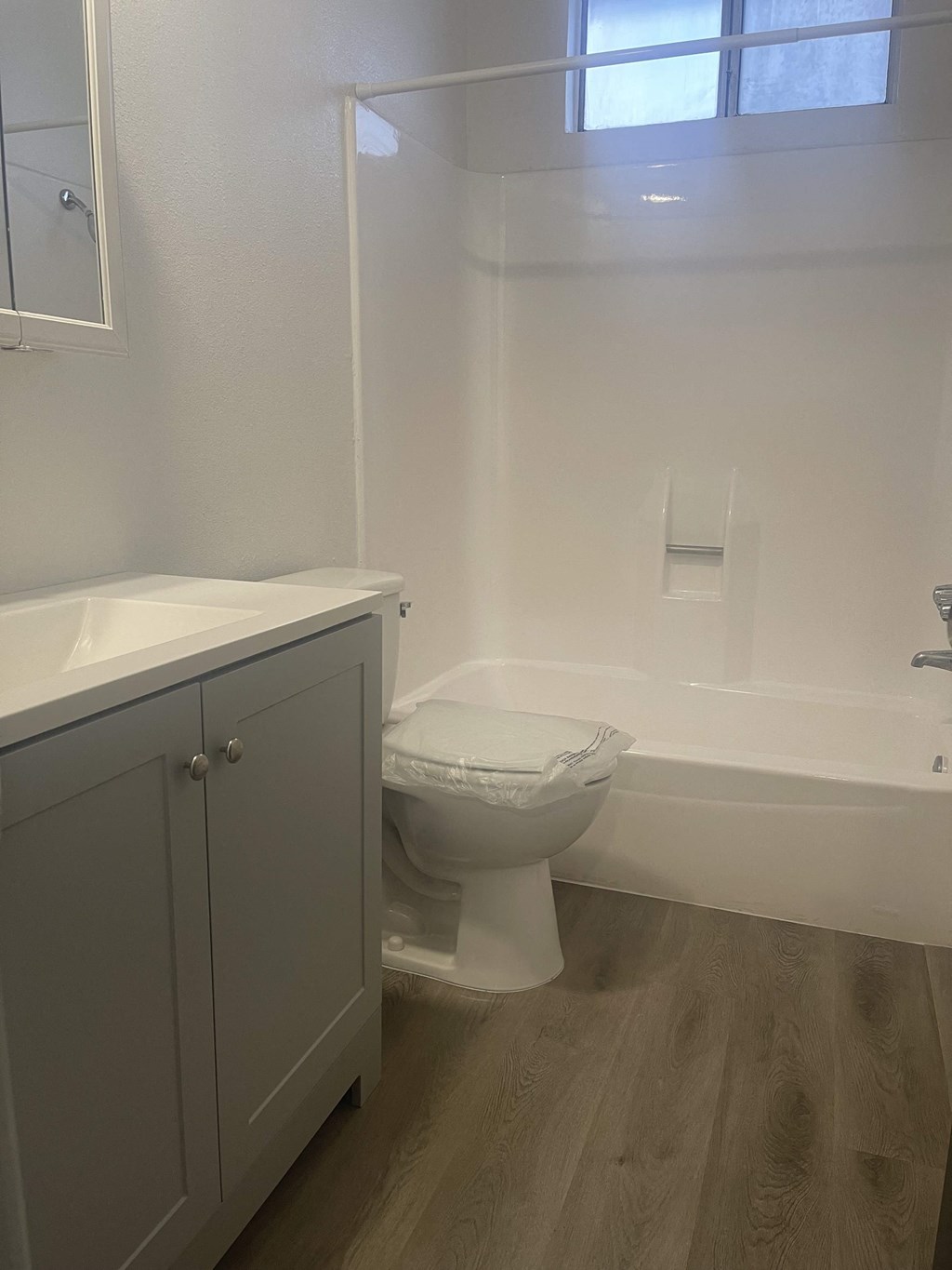 a bathroom with a toilet and a sink and a bath tub