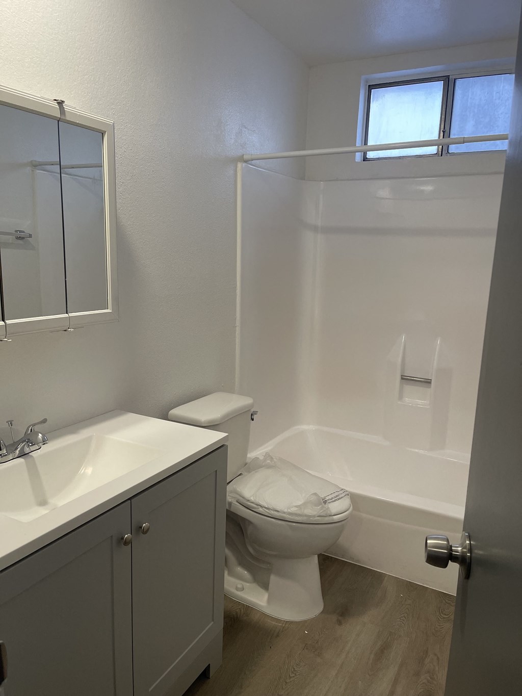a small bathroom with a toilet and a tub and a sink