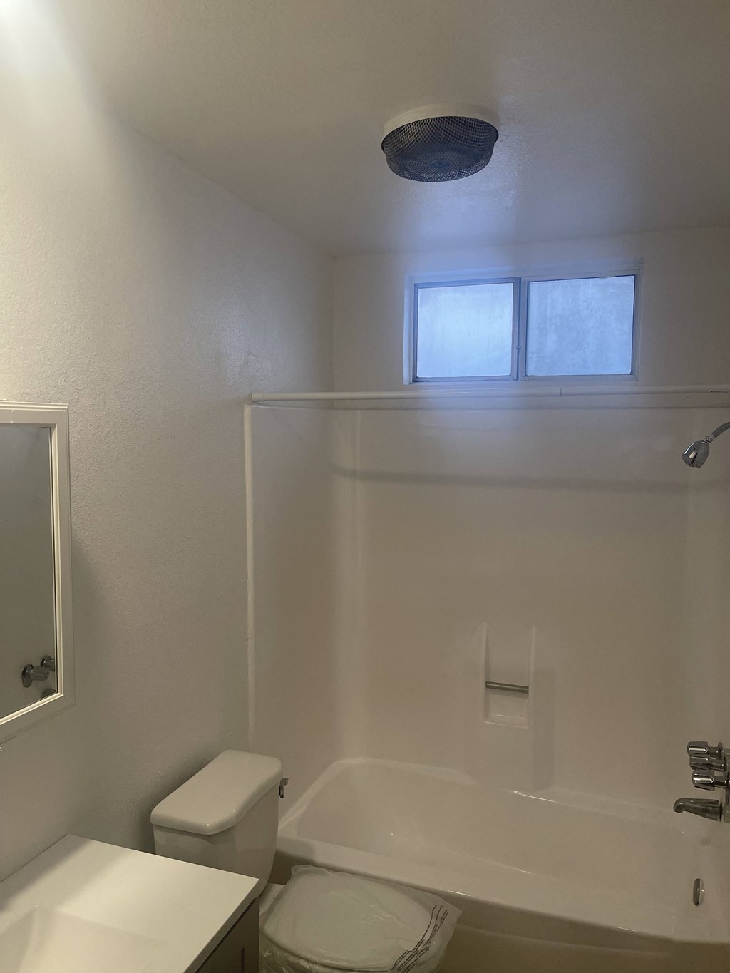 a bathroom with a toilet and a tub and a sink