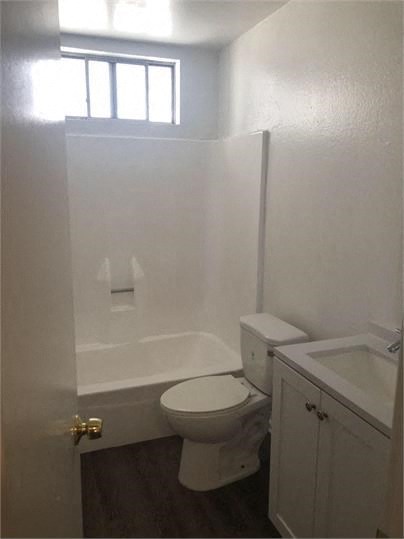 a bathroom with a toilet and a tub and a sink