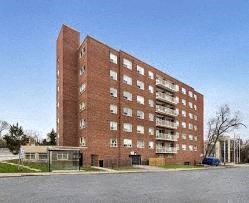 an apartment building on the corner of a street