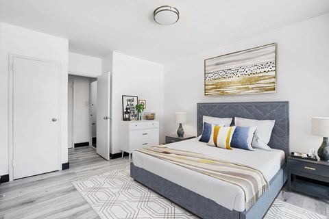 a bedroom with a large bed and a white closet