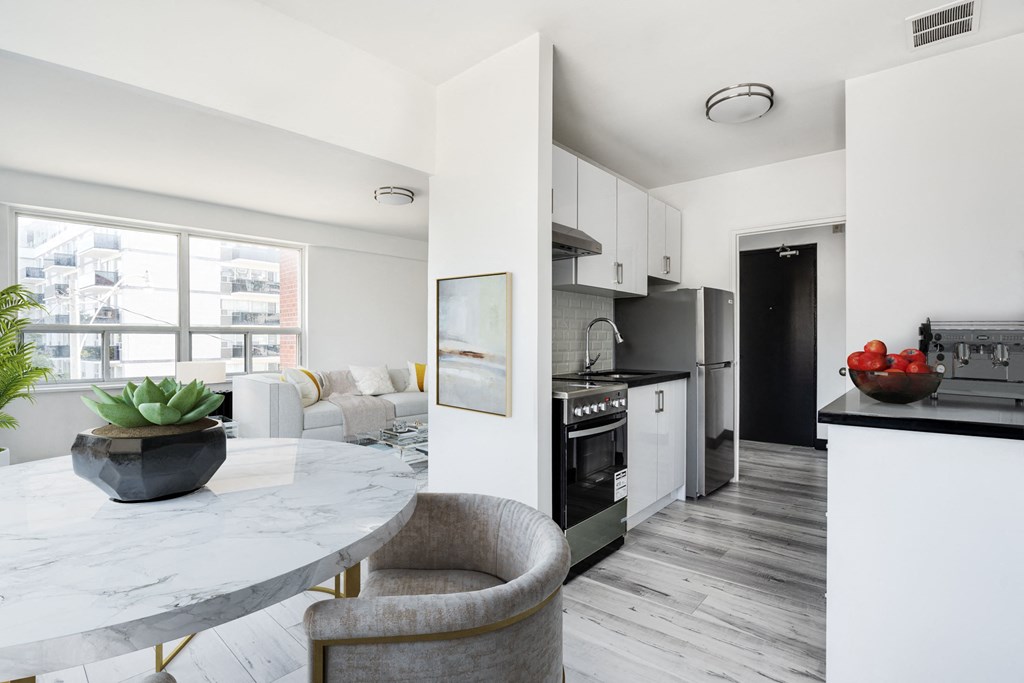 a kitchen and living room in an apartment with a marble table