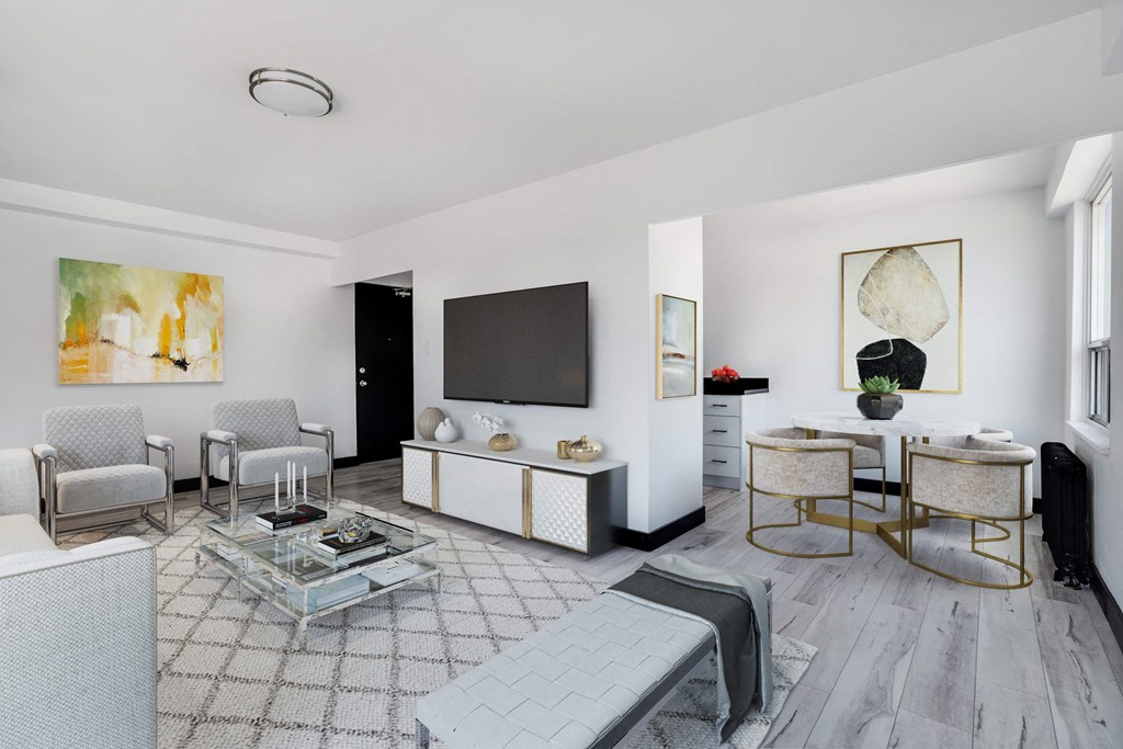 a living room with a table and chairs and a television