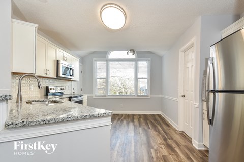 a kitchen with white cabinets and a counter top