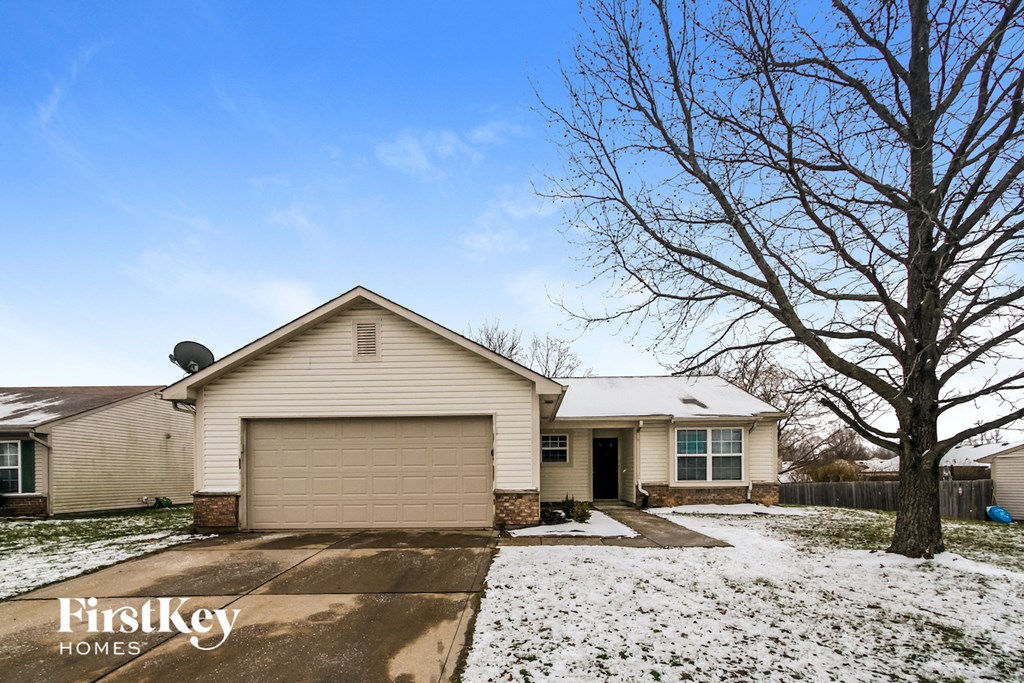 a white house with snow on the ground