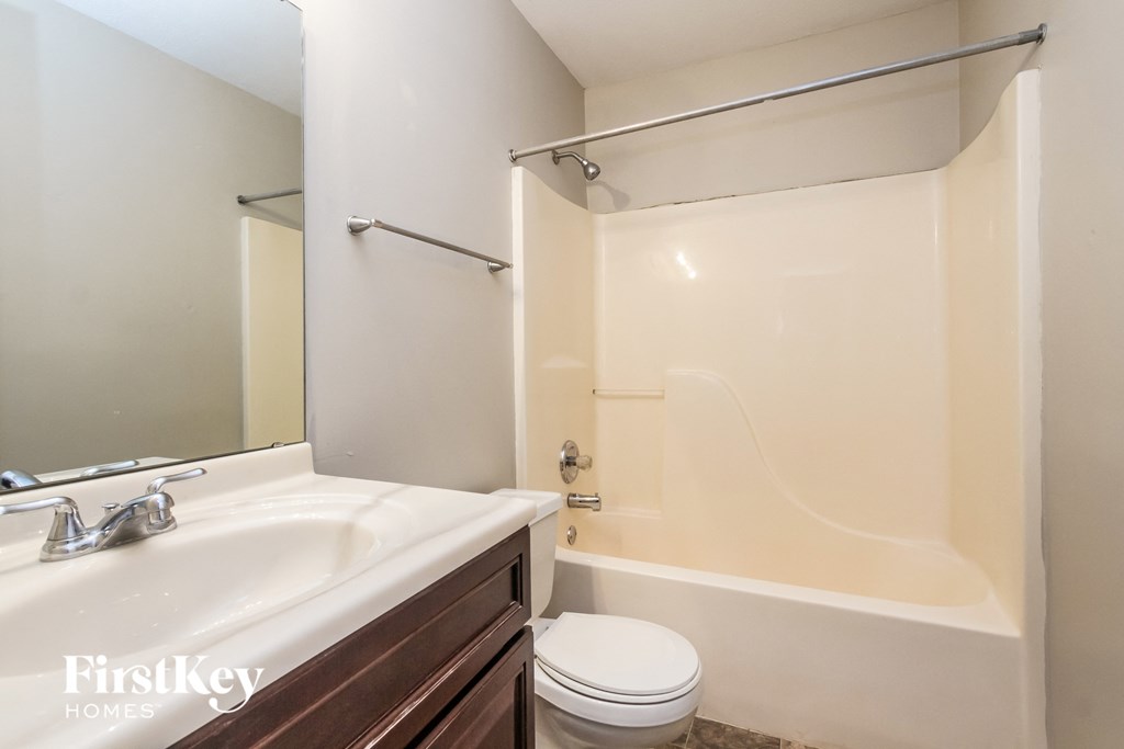 a bathroom with a sink and a toilet and a tub