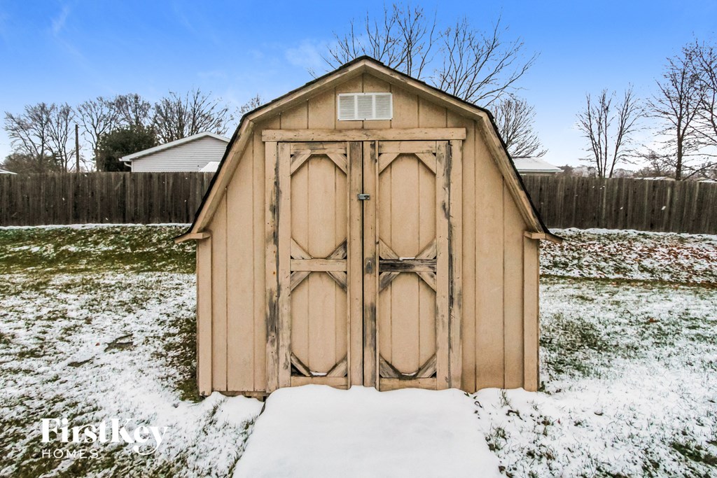 the chicken shed with doors in the snow