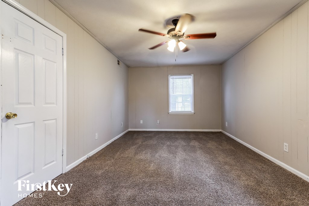 the master bedroom is spacious and has a ceiling fan