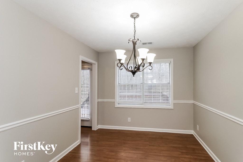 a dining room with a chandelier and a window