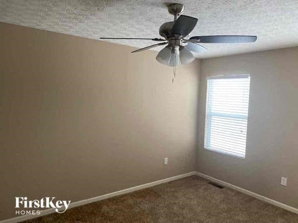A room with a ceiling fan and a window with blinds.