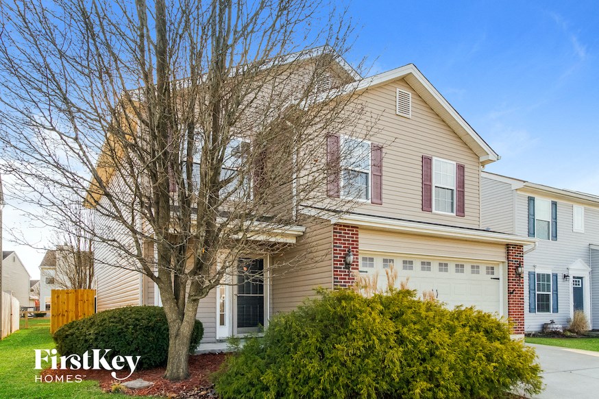 a house with a tree in front of it