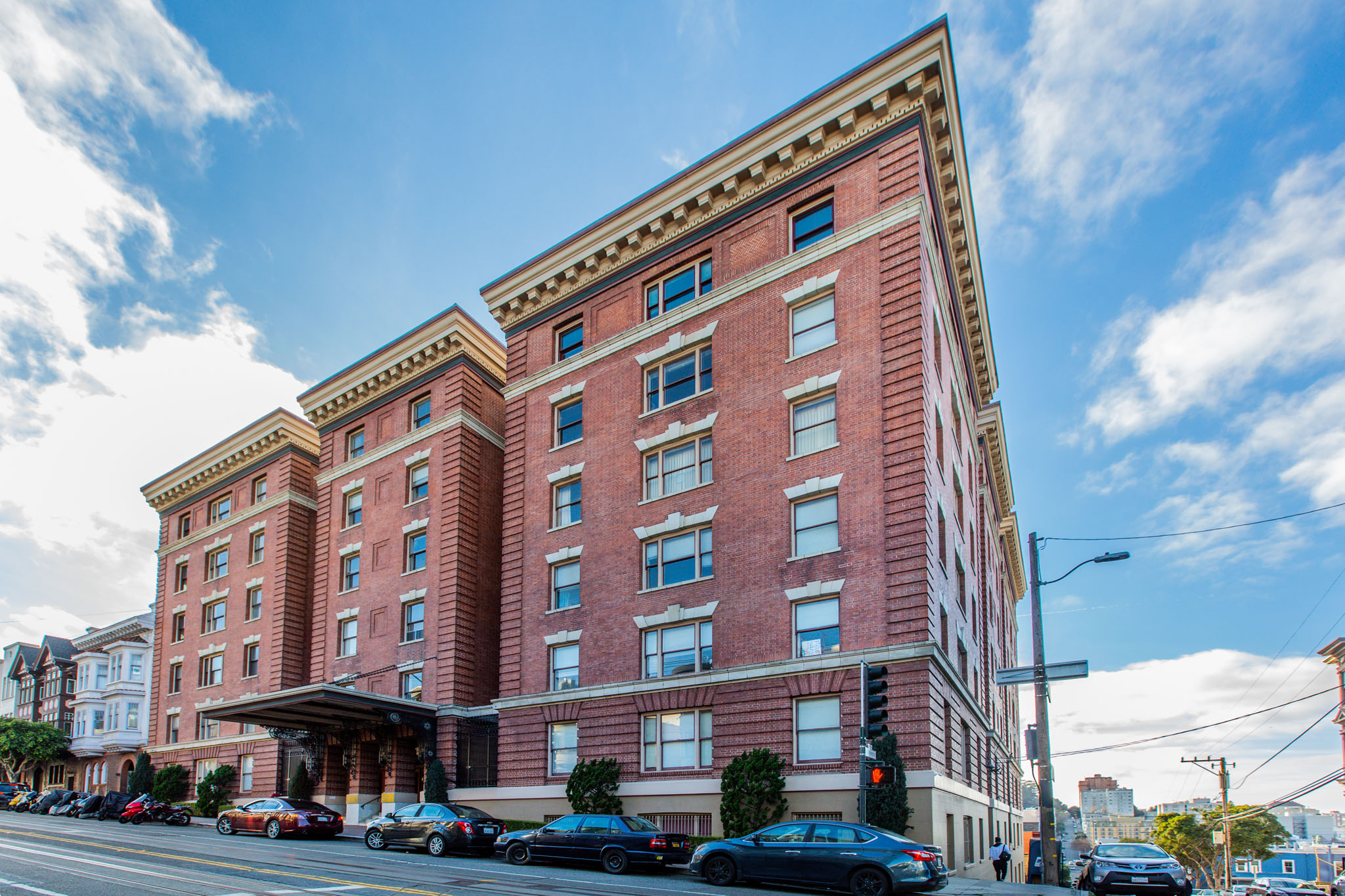 A large red brick building with a blue sky in the background.