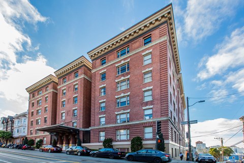 A large red brick building with a blue sky in the background.