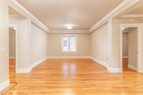 A room with wooden floors and white walls.