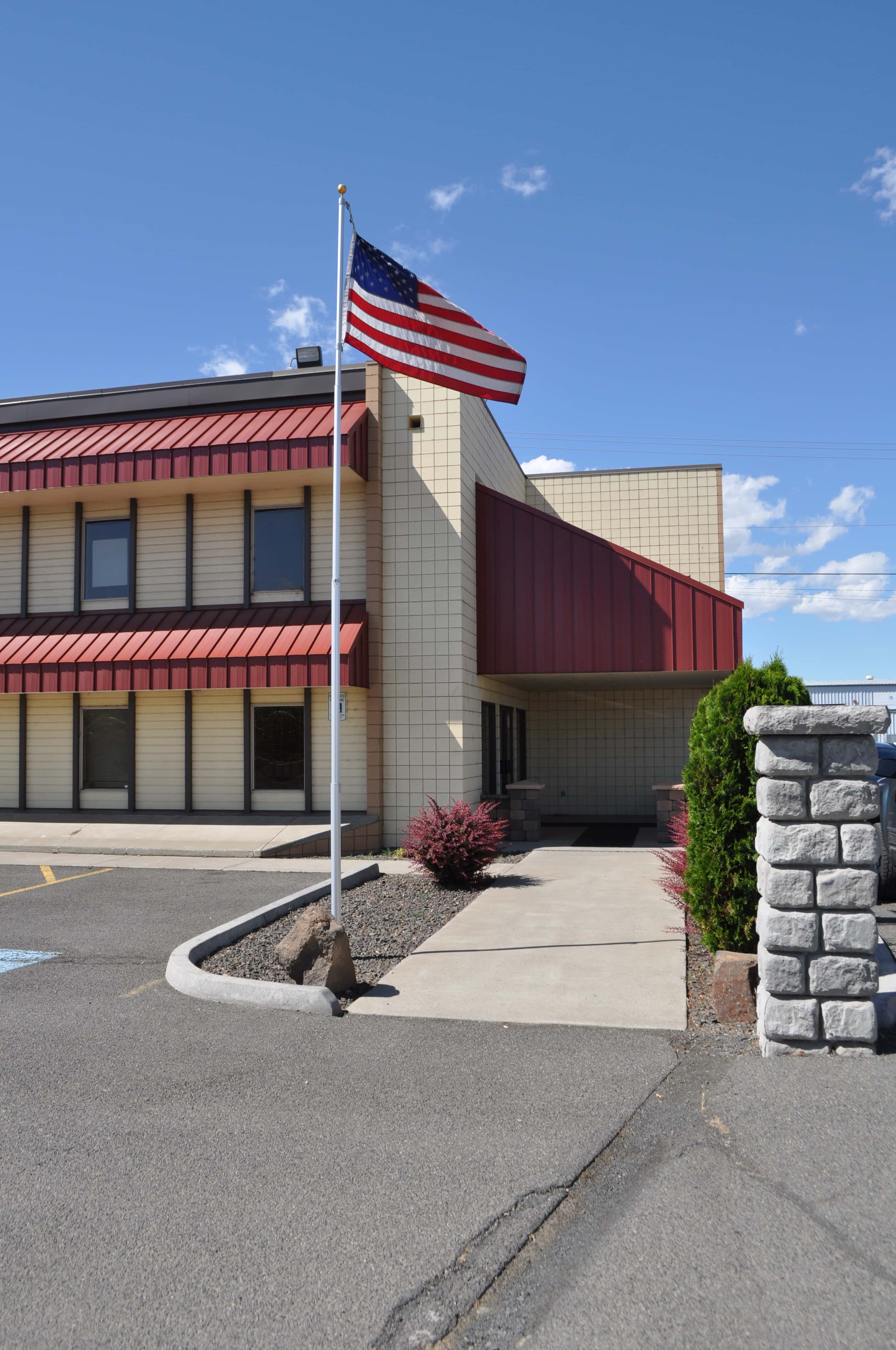 A building with a red awning and an American flag on top.