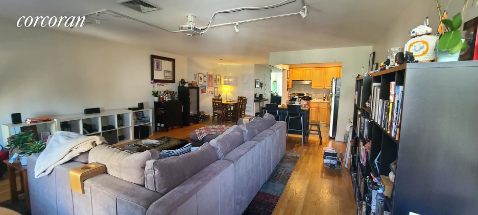 A living room with a couch and a television.
