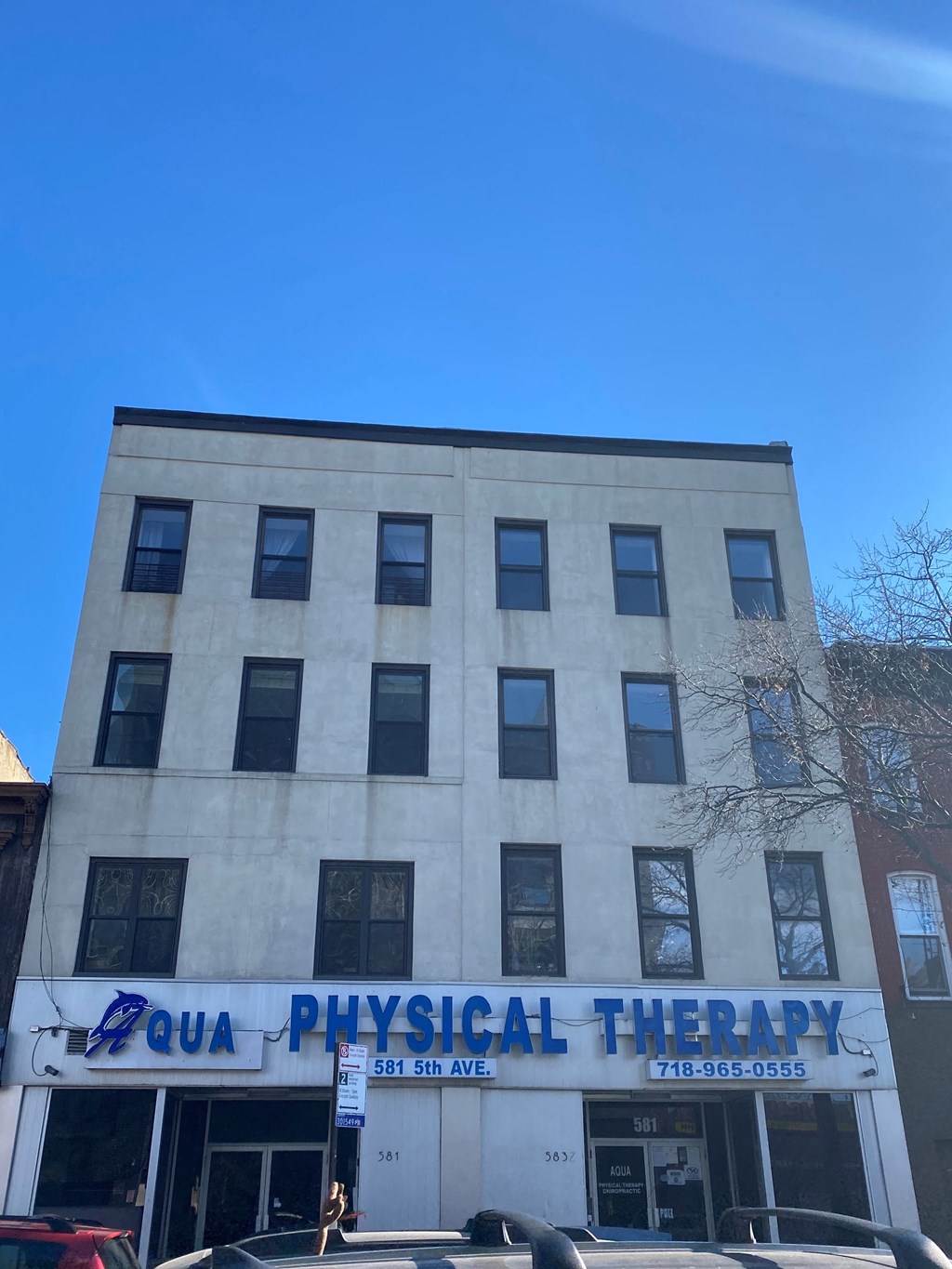 A building with a sign that says "QUA PHYSICAL THERAPY".