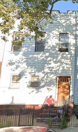 a white building with a tree shadow on it