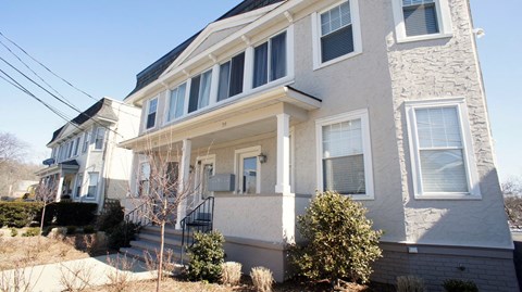 a white house with a front porch and stairs