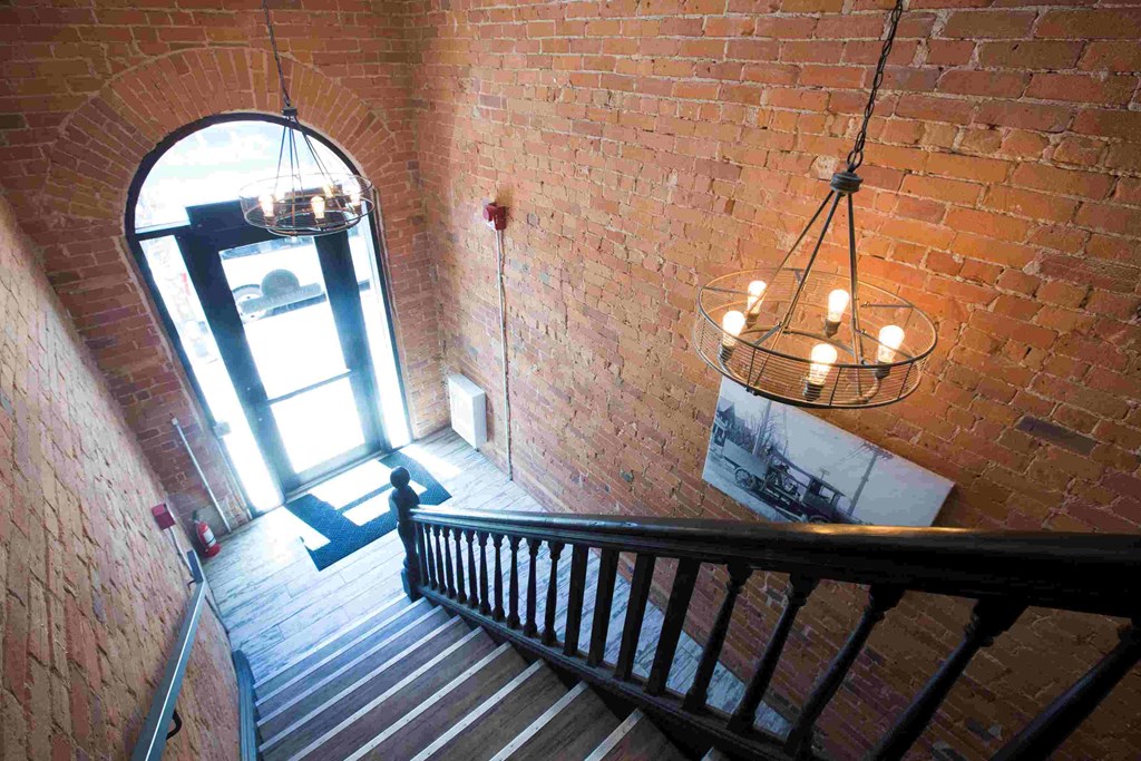 a staircase with a large window and a chandelier